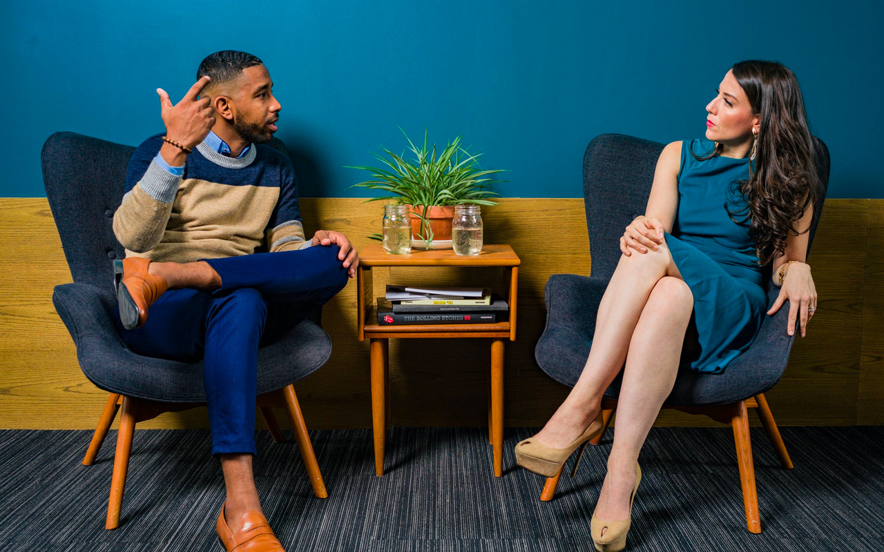 a woman is listening a man talk